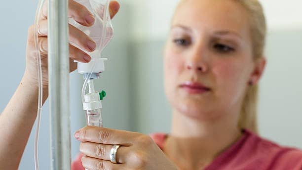 Nurse setting up an IV drip