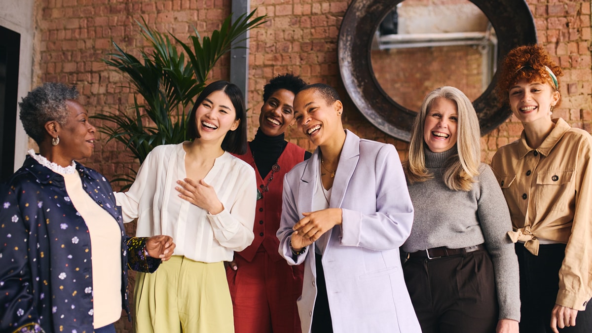 Diverse women laughing together.