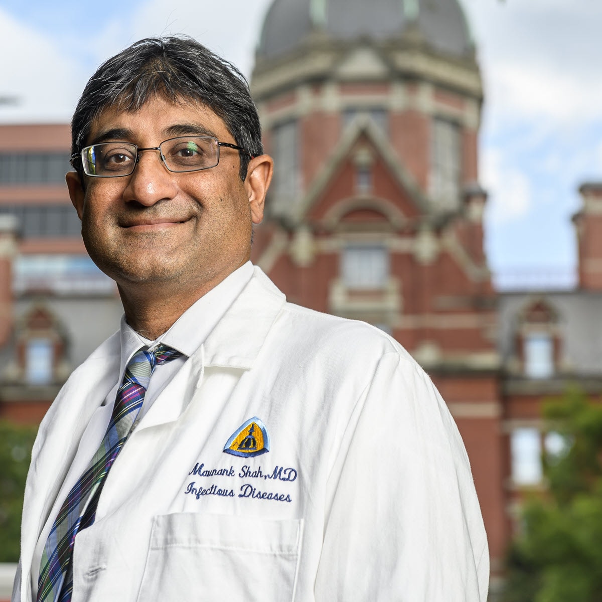 2024 TB Champion Maunank Shah smiling wearing a white coat