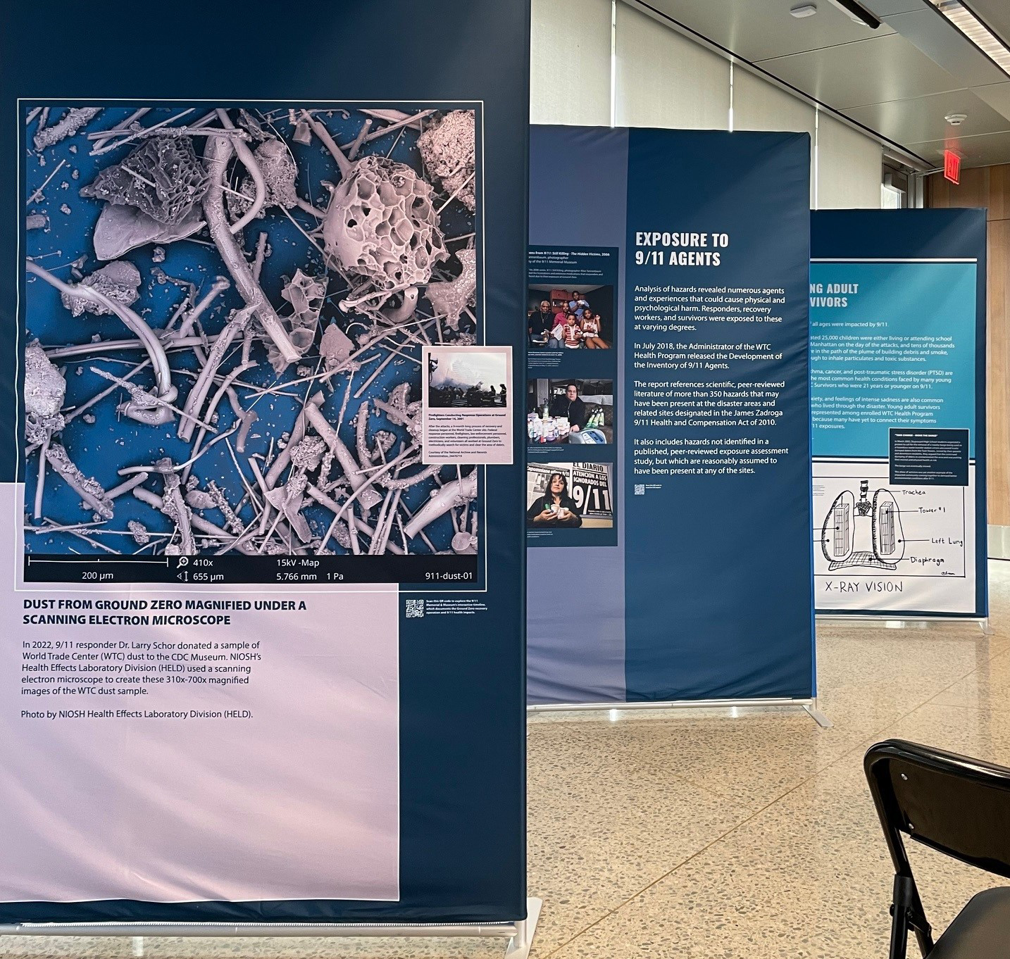 Exhibit display panels with text and photos explaining health effects of 9/11. 