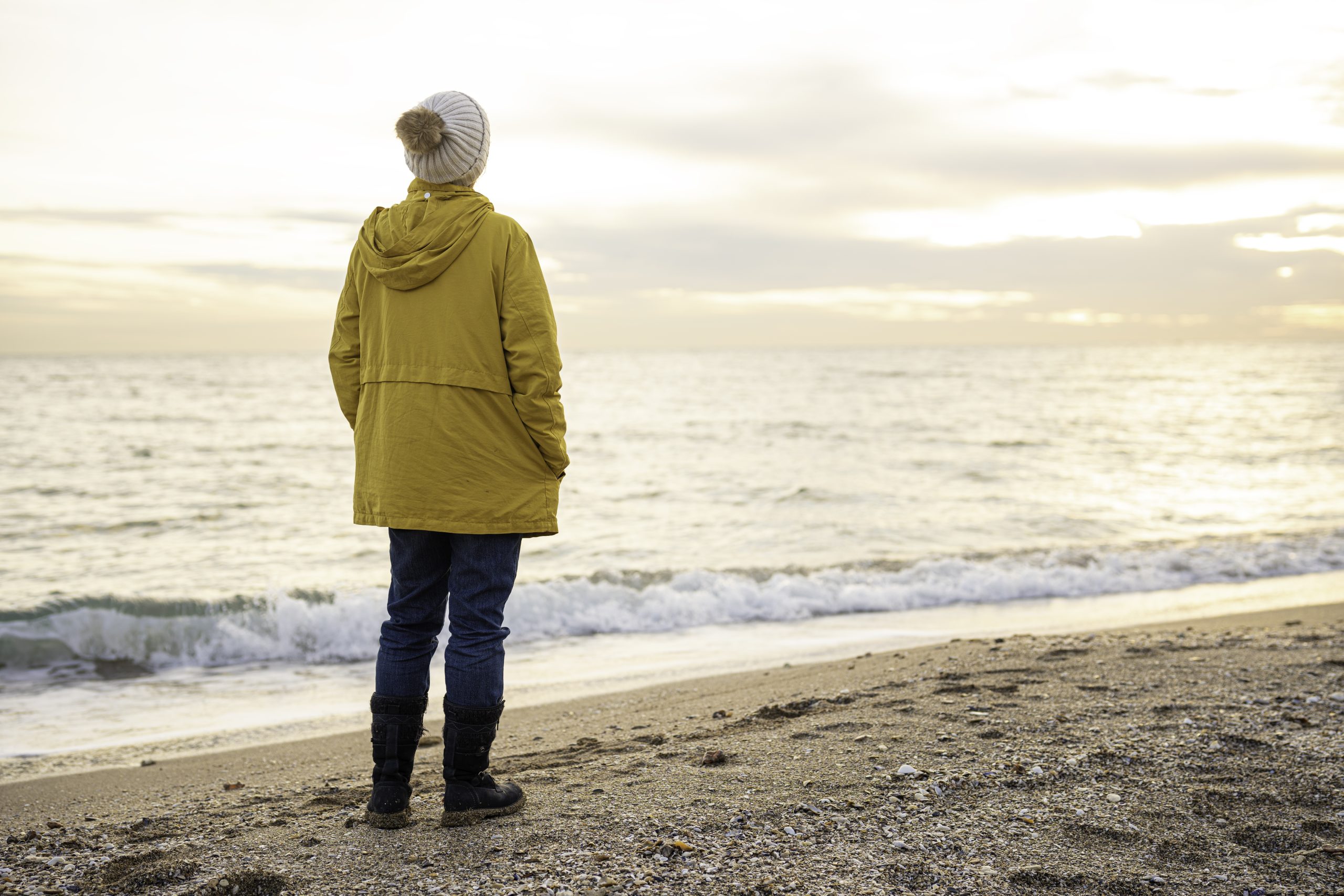 Traveler looking at the landscape on a beach.