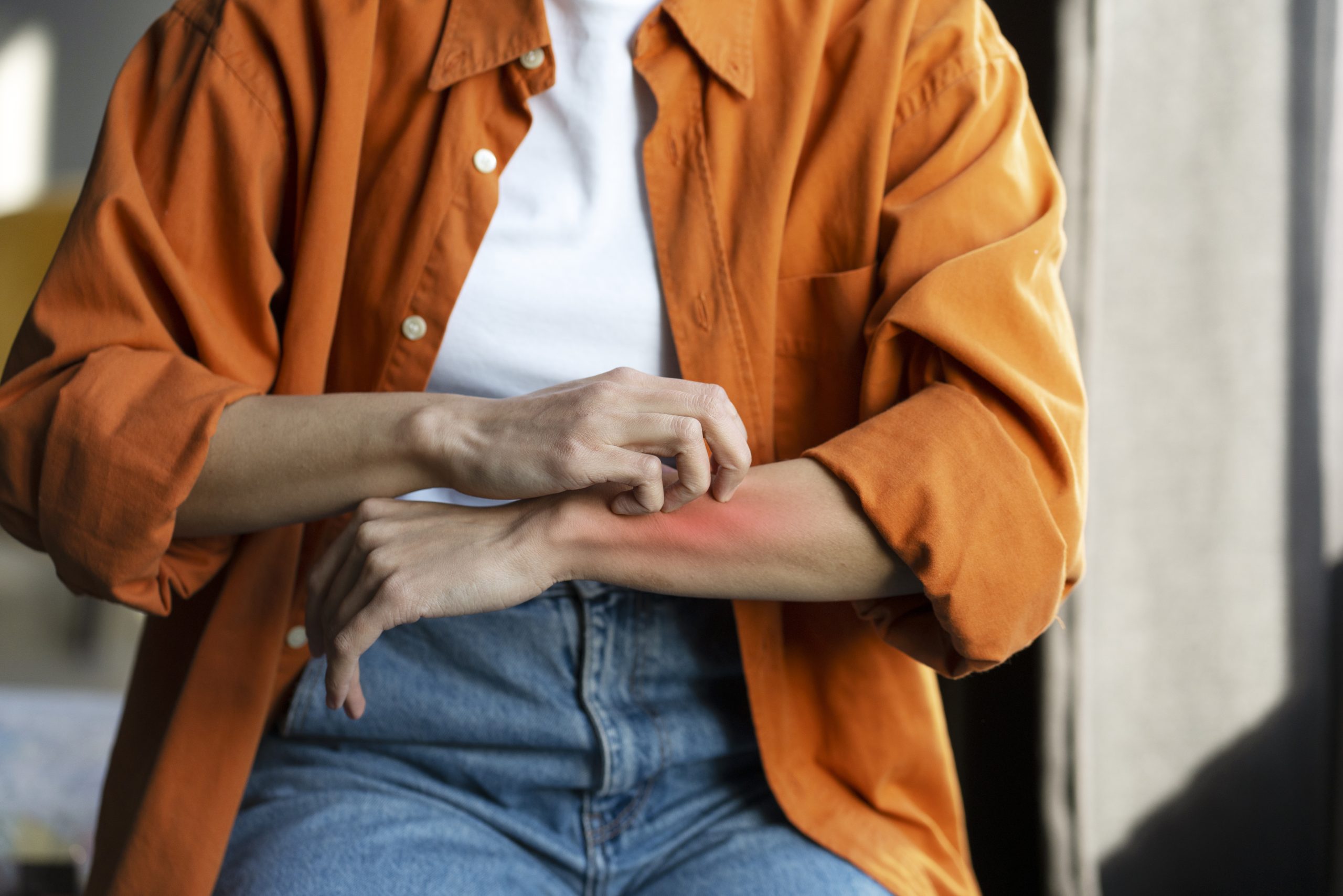 Traveler itching their arm.