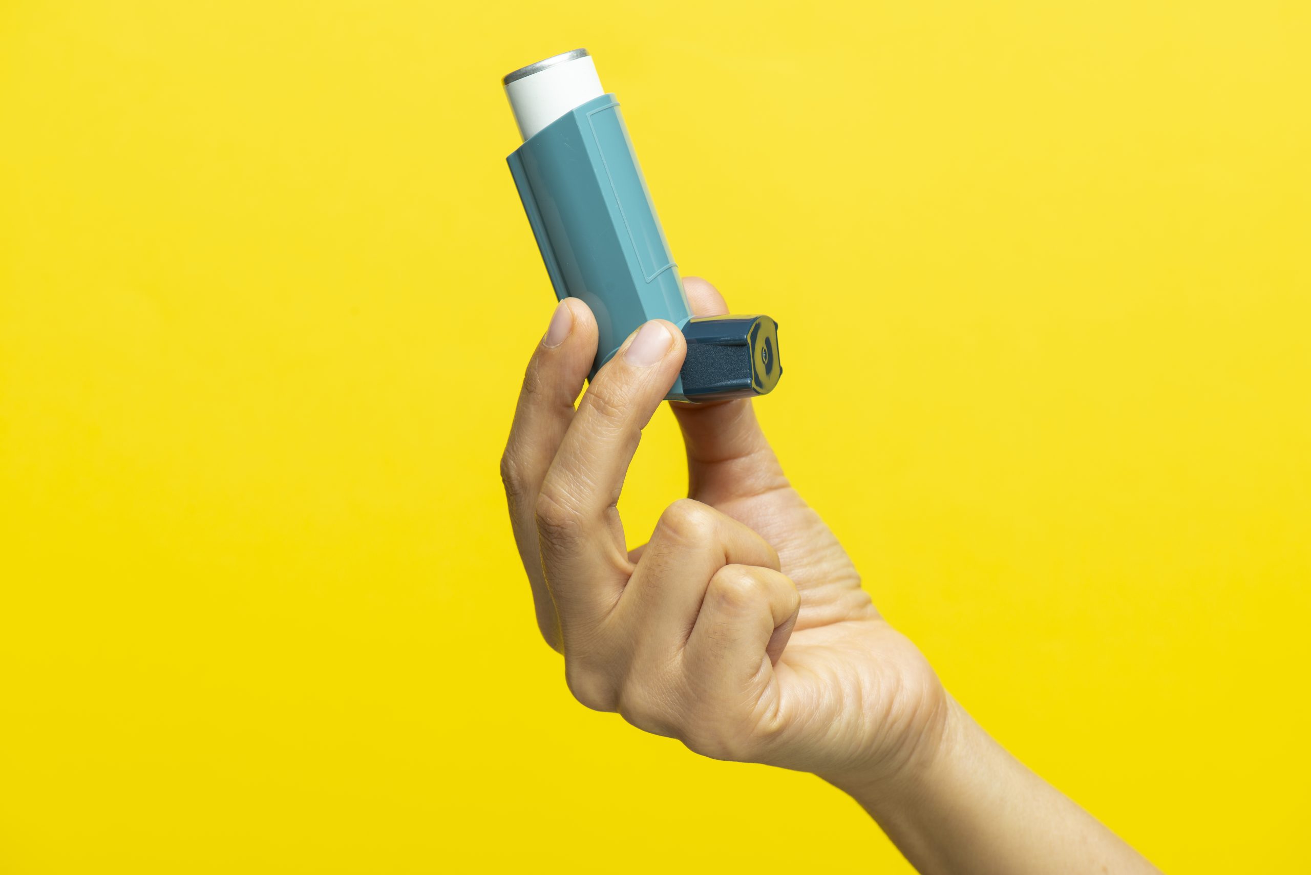 Traveler holding an inhaler.