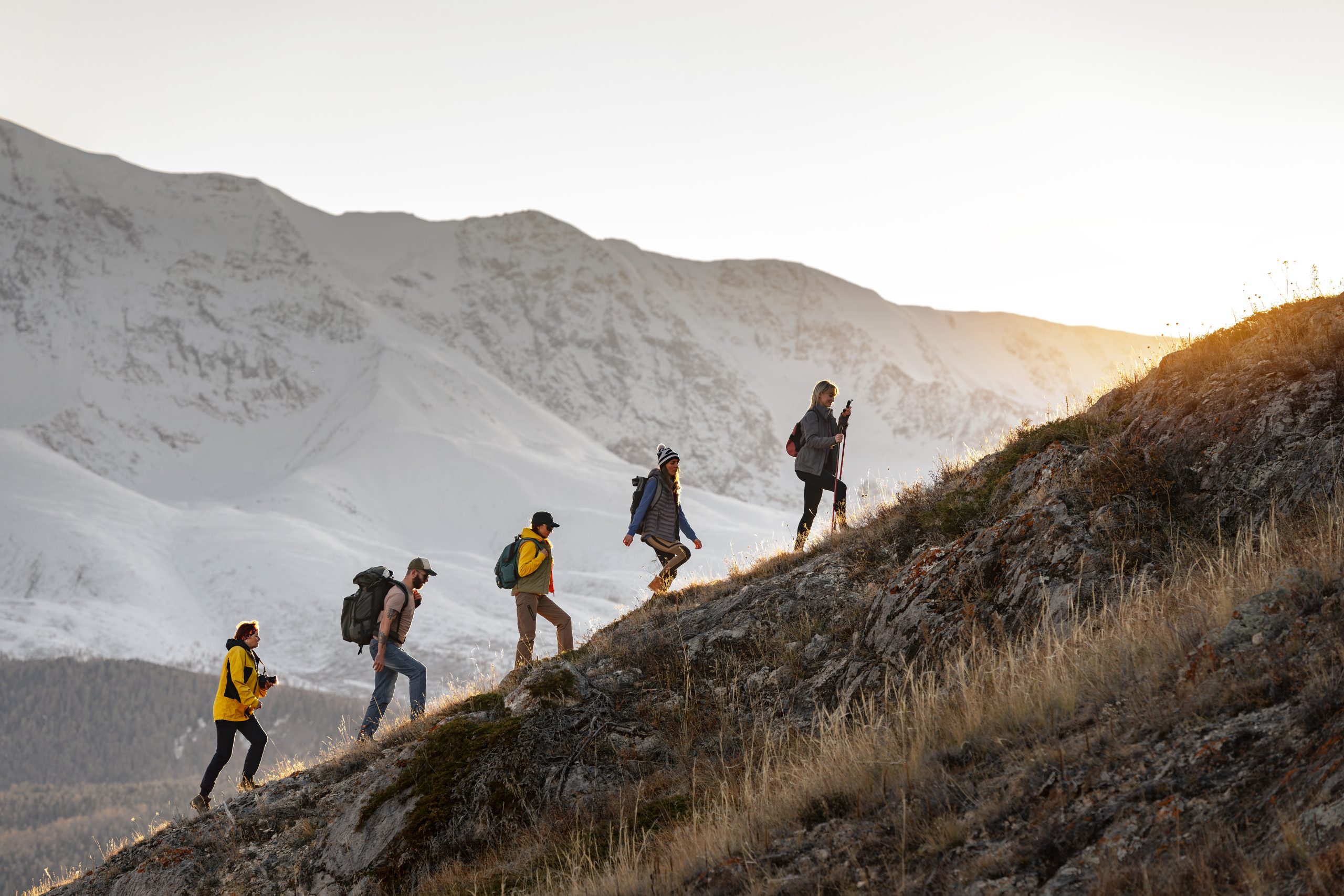 Group of travelers hiking uphill.