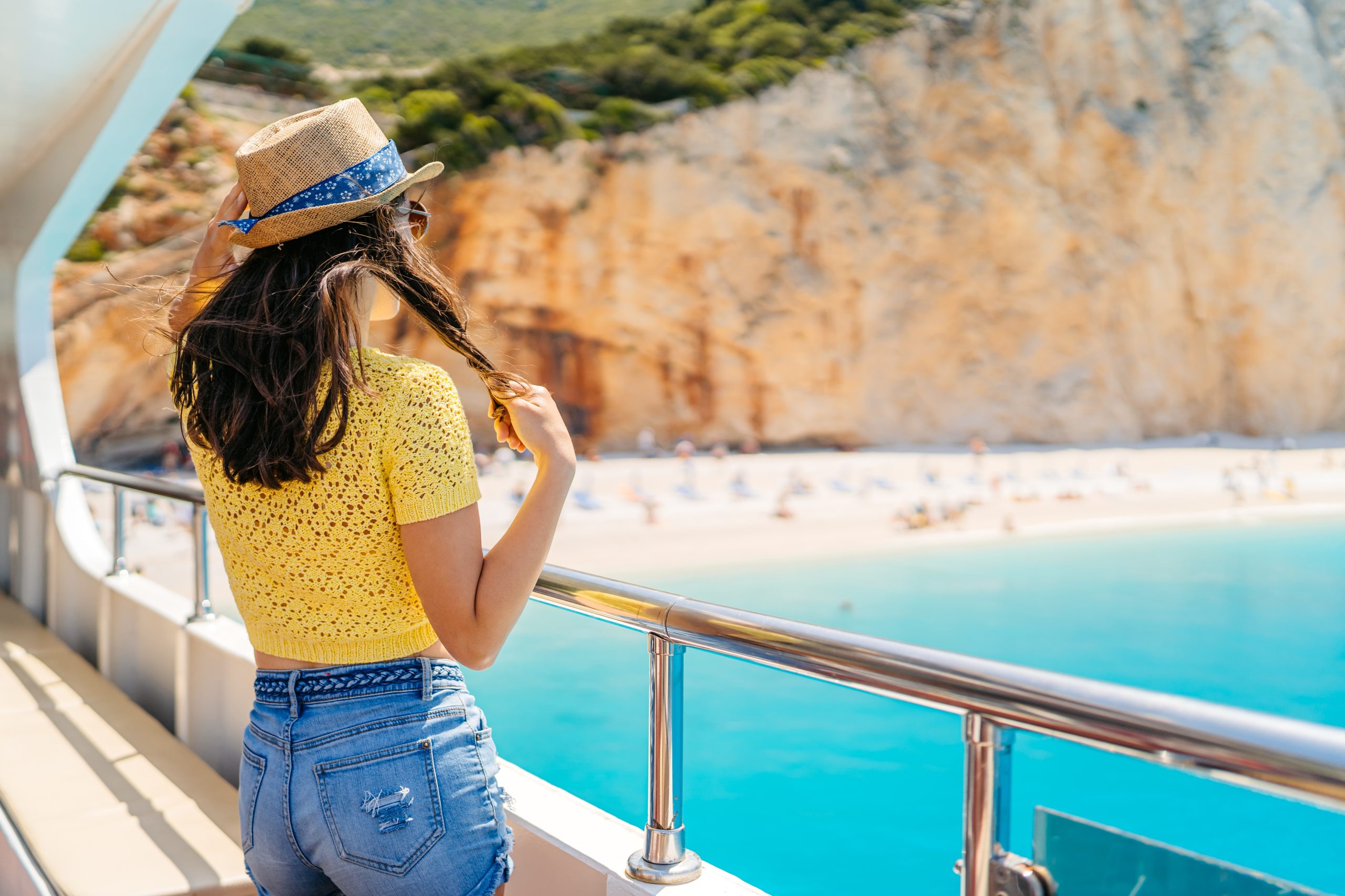 Traveler looking at the view from a cruise ship deck.