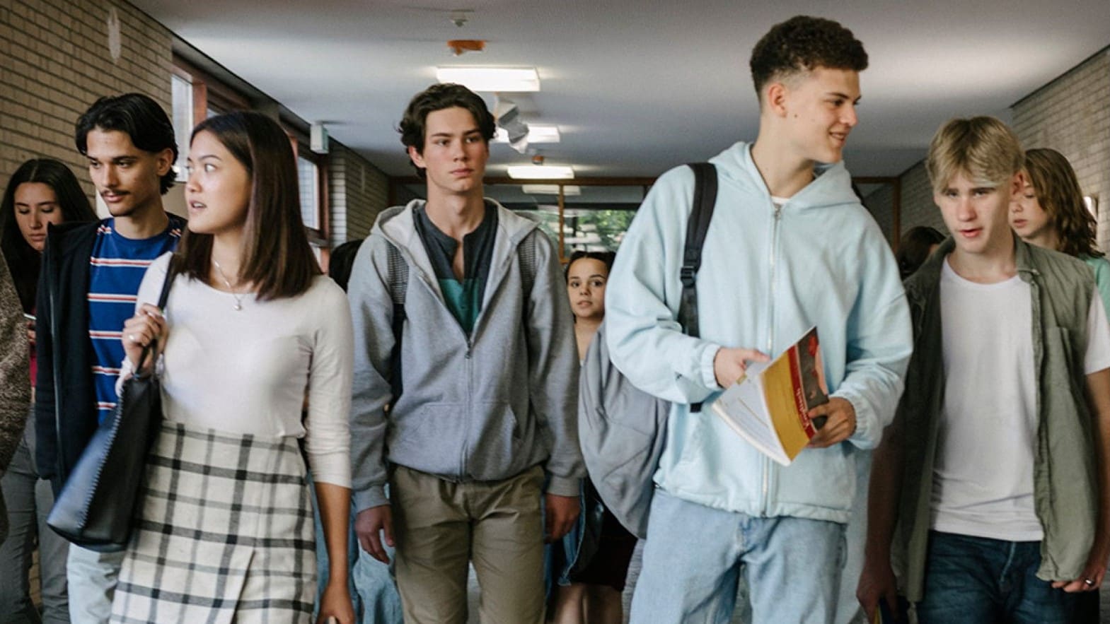 Students walking through a school hallway.